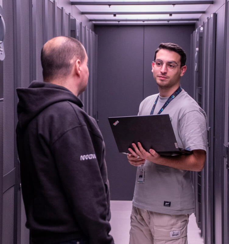 Two employees conversing in a data center