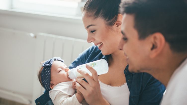 Parents feeding the baby