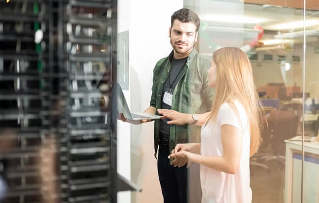 Two people looking at servers