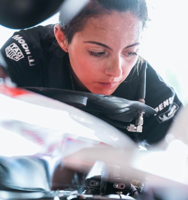  Porsche technician inspecting an engine