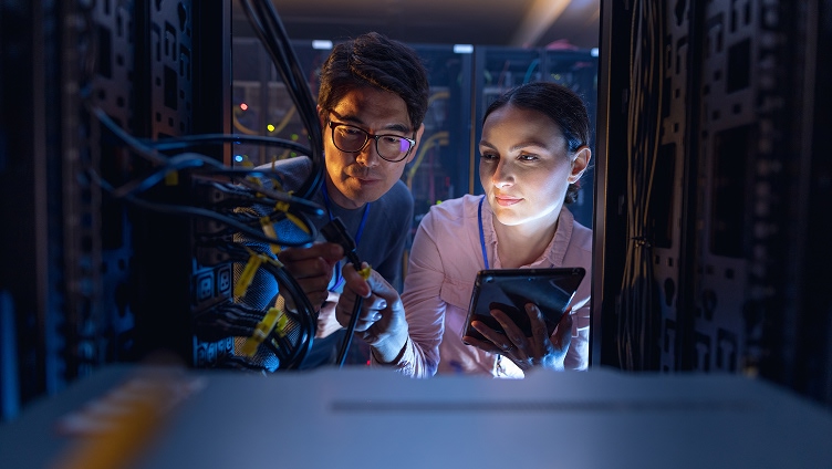 Two people inspecting equipment