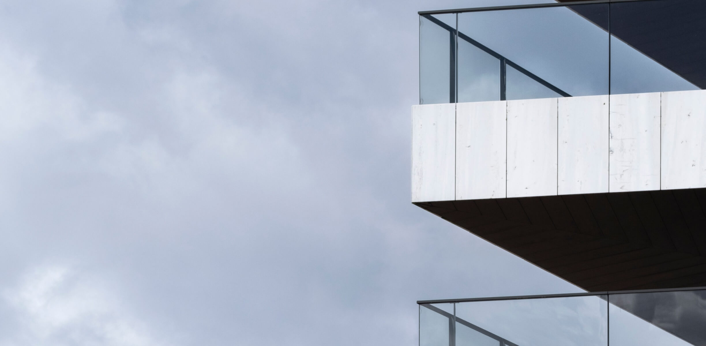 View of building with balcony and clouds