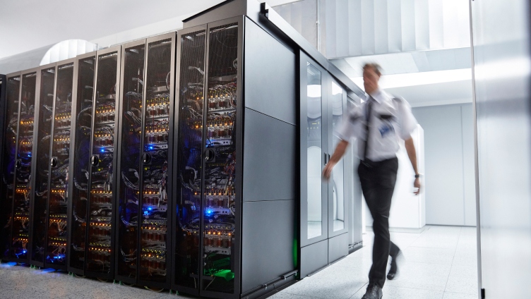 person walking inside data center
