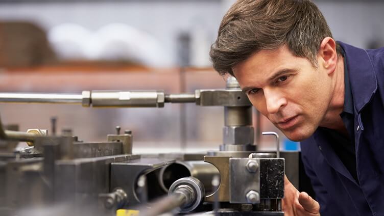 person closely watching the machine