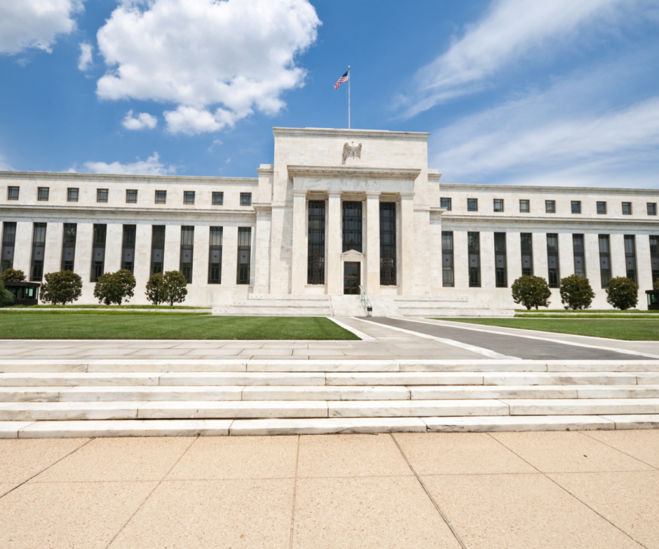 front view of a building with pillars and grass in front of the building