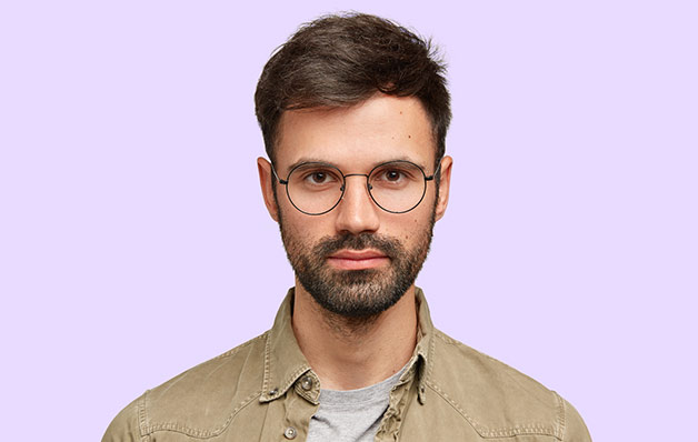 man with glasses on a purple background